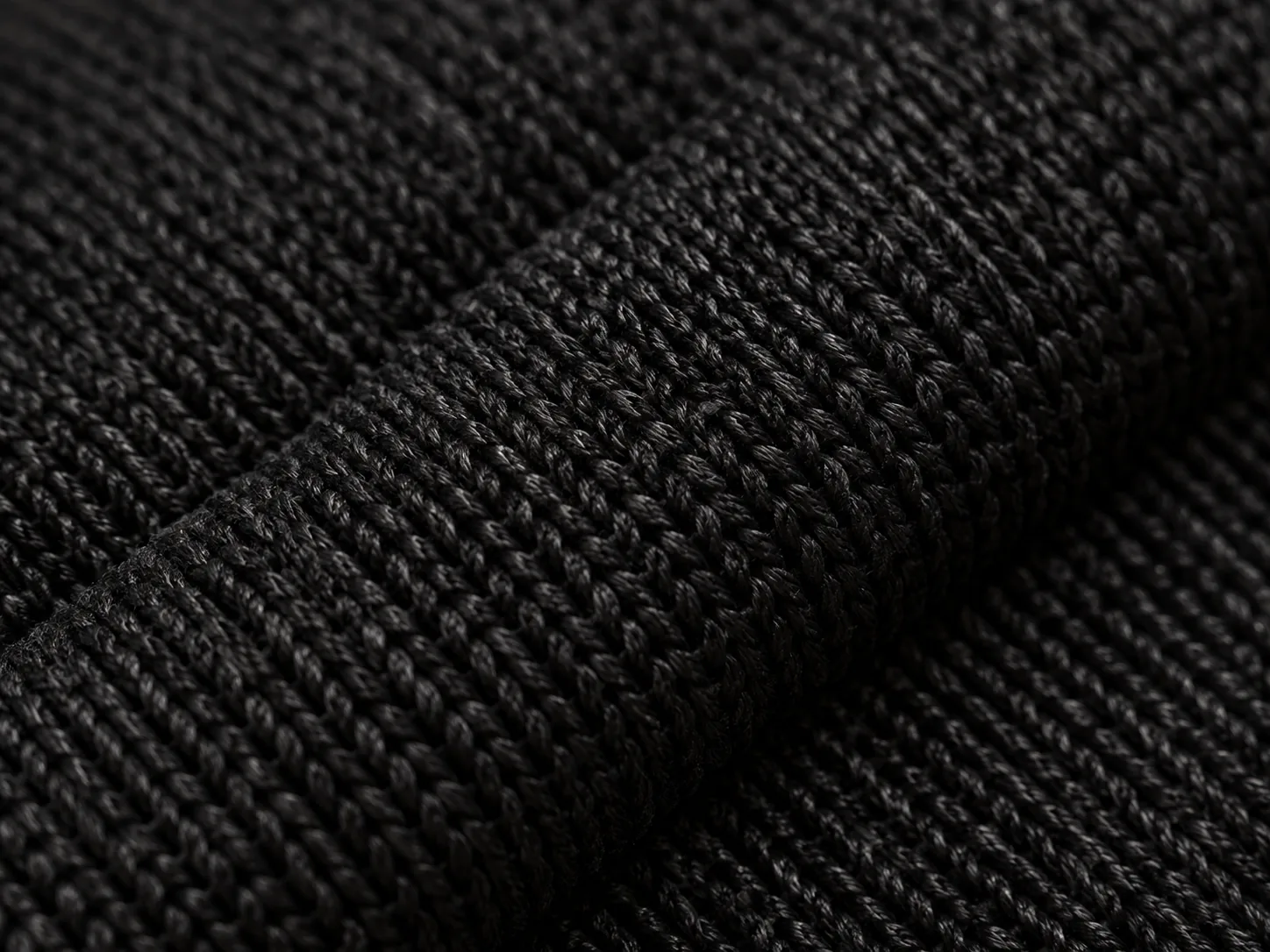 Macro of dense black knit fabric